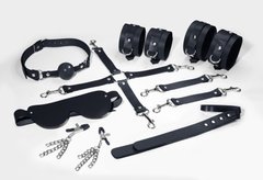Набір Feral Feelings BDSM Kit 7 Black, наручники, поножі, конектор, маска, паддл, кляп, затискачі